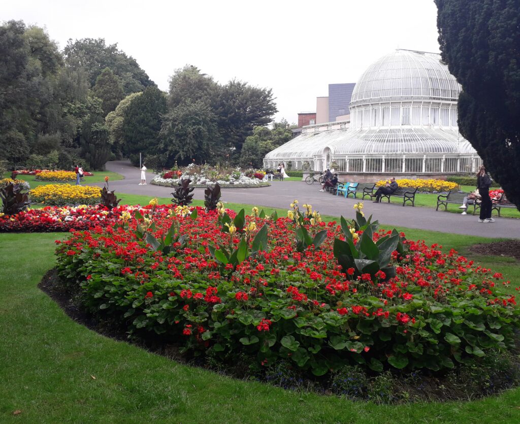 Flower beds and Victorian Palm House greenhouse of Belfast Botanic Gardens